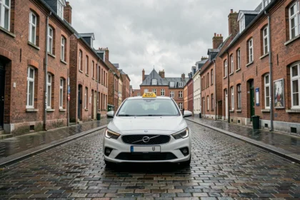 Un taxi moderne garé sur une rue pavée d'une ville du Pas-de-Calais avec architecture flamande en arrière-plan